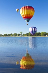 Hot air balloons touching the water